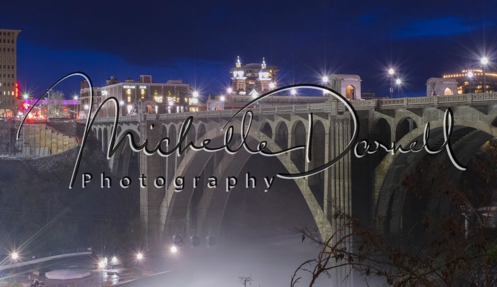 The Monroe Street bridge looms over the Spokane Falls gondola ride at night in downtown Spokane, Washington. 72 dpi, 300 dpi, 600 dpi